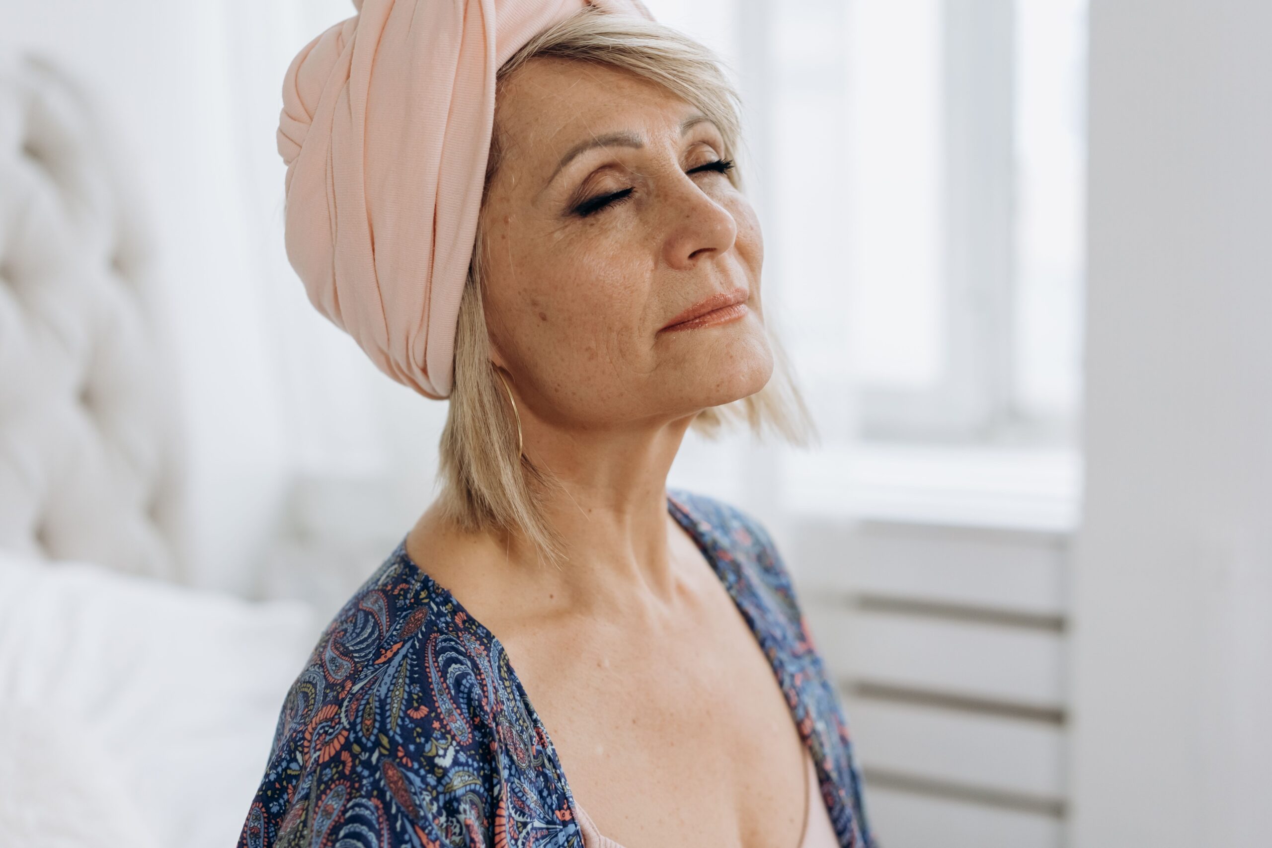 A peaceful woman with loose skin and some facial volume lost